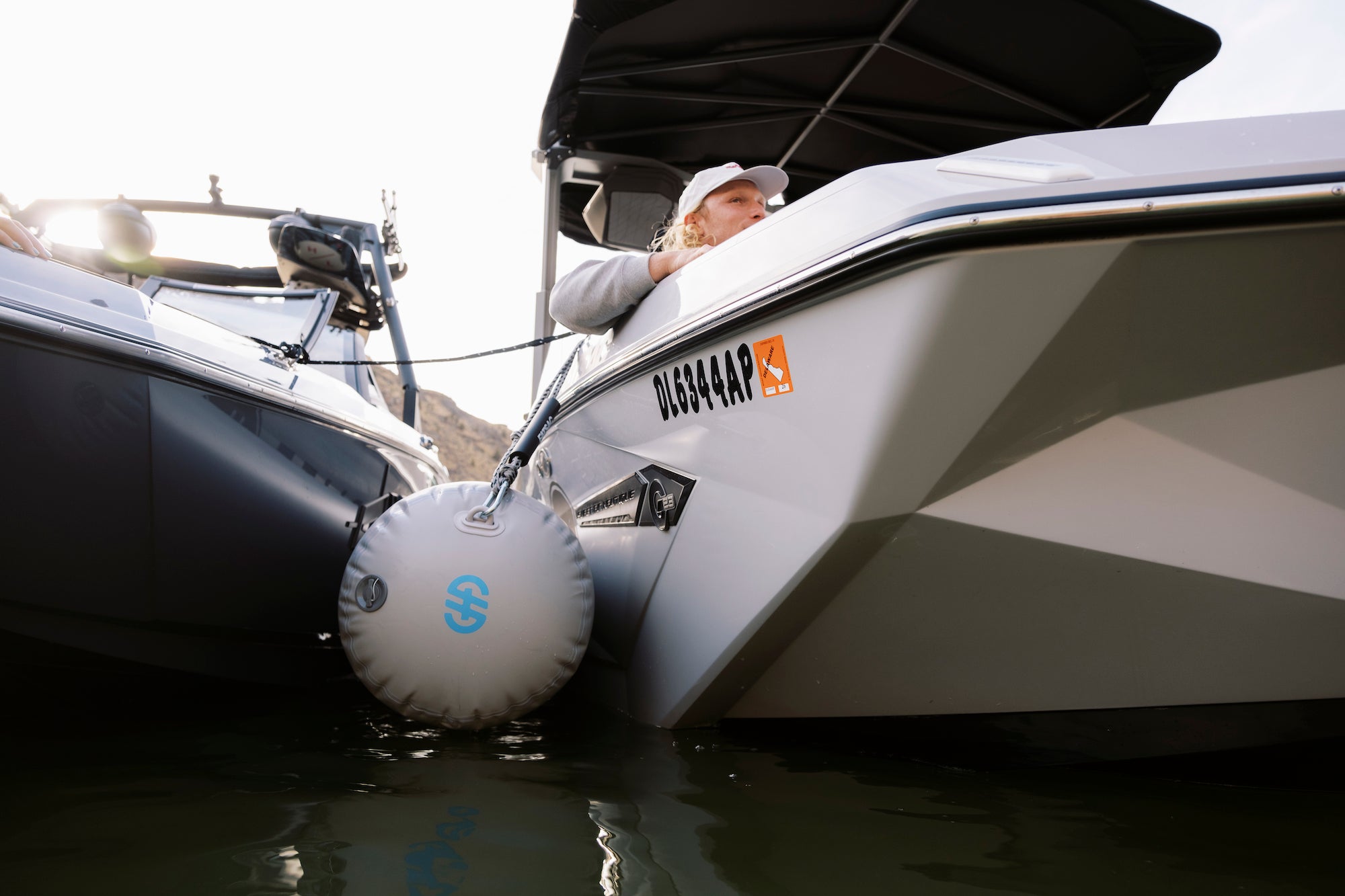 Gray Seipel Marine boat bumper protecting two boats tied together on the water.