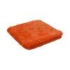 Angled view of the Plush Detailing Towel in orange, folded with a dense microfiber texture.