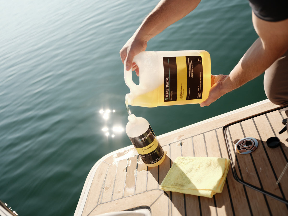 Seipel Marine water spot remover refill jug on a boat deck with calm marina water behind.