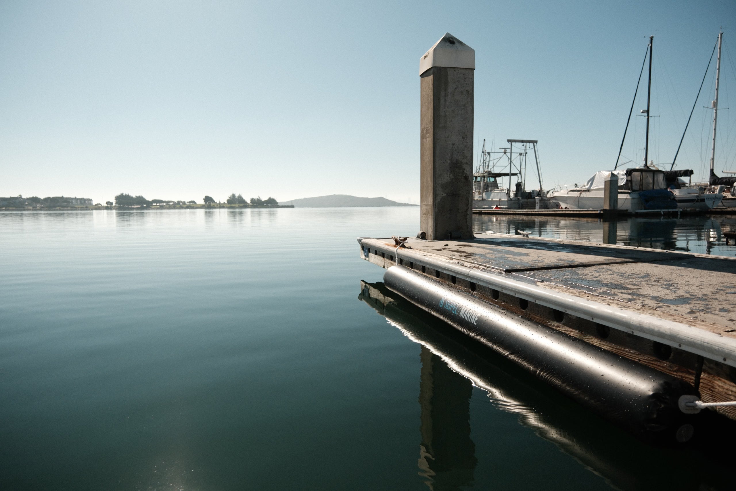 Seipel Marine inflatable dock bumper mounted horizontally along a marina dock.